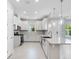 Open kitchen featuring a large island, stainless steel appliances, white cabinetry, and ample counter space at 6107 Mesa Gln, Bradenton, FL 34203