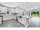 Lovely kitchen featuring stainless appliances, granite countertops, a spacious island, and a view of the backyard at 6107 Mesa Gln, Bradenton, FL 34203
