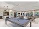 Spacious recreation room with pool table, kitchen, tables, and chairs at 6107 Mesa Gln, Bradenton, FL 34203
