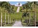 Scenic community walking path lined with palm trees, leading to steps on a hill, perfect for a stroll at 6107 Mesa Gln, Bradenton, FL 34203