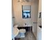 Small bathroom with toilet and sink, undergoing renovation at 6504 Lincoln Rd, Bradenton, FL 34203