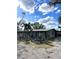 Ranch style home with metal roof and mature landscaping at 6504 Lincoln Rd, Bradenton, FL 34203