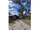 Home showcasing side yard and mature oak trees with Spanish moss at 6504 Lincoln Rd, Bradenton, FL 34203