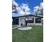 Tan house with large windows and a small patio at 6504 Lincoln Rd, Bradenton, FL 34203