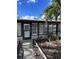 Front entrance with black framed windows and landscaping at 6504 Lincoln Rd, Bradenton, FL 34203