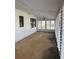 Large Florida room with white walls and ceiling fan at 6504 Lincoln Rd, Bradenton, FL 34203