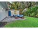 Inviting backyard features a cozy patio, outdoor seating, a fire pit and a lush lawn at 730 40Th St, Sarasota, FL 34234