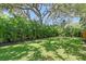 Beautiful backyard featuring lush green grass and mature tropical landscaping, providing a serene outdoor space at 730 40Th St, Sarasota, FL 34234