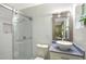 Tiled bathroom with glass shower, white sink, and bright lighting at 730 40Th St, Sarasota, FL 34234