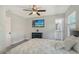 Bedroom with ceiling fan, mounted television, and an ensuite bathroom entrance at 730 40Th St, Sarasota, FL 34234
