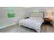 Sunlit bedroom with large window and wood-accented headboard at 730 40Th St, Sarasota, FL 34234