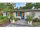 Charming front entrance with blue door, paver walkway, and well-maintained landscaping at 730 40Th St, Sarasota, FL 34234