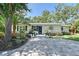 Charming front entrance with blue door, paver walkway, and well-maintained landscaping at 730 40Th St, Sarasota, FL 34234