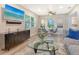 Cozy living room and dining area featuring modern decor, stylish furniture, and a wall-mounted TV at 730 40Th St, Sarasota, FL 34234
