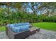 Outdoor patio featuring modern seating and a fire pit, surrounded by a lush lawn at 730 40Th St, Sarasota, FL 34234