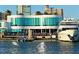 White waterfront restaurant with glass walls and outdoor seating, alongside yachts docked in the marina at 730 40Th St, Sarasota, FL 34234