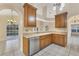 Kitchen with corner sink, light wood cabinets, and stainless steel appliances at 4882 Tivoli Ave, Sarasota, FL 34235