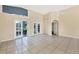Bright living room with tile floors and access to patio at 4882 Tivoli Ave, Sarasota, FL 34235