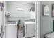 Convenient laundry room with washer, dryer, and hanging rod at 10732 Klee Ave, Bradenton, FL 34212