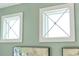 Close-up of three windows with white trim and gridded design, showcasing elegant interior details at 10732 Klee Ave, Bradenton, FL 34212