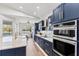 Modern kitchen with stainless steel appliances, marble countertops, and blue cabinetry at 12147 Maple Ridge Dr, Parrish, FL 34219