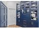 Well-equipped kitchen featuring blue cabinetry and glass-front shelving at 12147 Maple Ridge Dr, Parrish, FL 34219