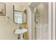 Small bathroom with pedestal sink, shower, and mirrored medicine cabinet at 14019 18Th E Pl, Bradenton, FL 34212