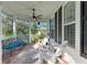 Relaxing front porch with white rocking chairs and ceiling fan at 14019 18Th E Pl, Bradenton, FL 34212