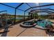 Beautiful pool and spa with a screened-in lanai overlooking a serene lake at 19864 Petrino St, Venice, FL 34293