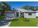 Single-story home with gray siding, paved driveway, and lush lawn at 212 50Th Street Nw Ct, Bradenton, FL 34209