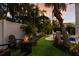 Relaxing backyard with fire pit and seating area next to the pool at 213 83Rd St # East, Holmes Beach, FL 34217