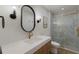 Modern bathroom with a gold-trimmed shower and updated vanity at 213 83Rd St # East, Holmes Beach, FL 34217