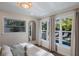 Bright bedroom with pool view and large windows at 213 83Rd St # East, Holmes Beach, FL 34217
