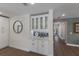 Well-appointed butler's pantry with white cabinets and glass doors at 213 83Rd St # East, Holmes Beach, FL 34217