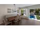 Elegant dining area with built-in bench seating and view of private pool at 213 83Rd St # East, Holmes Beach, FL 34217