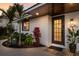 Modern front entrance with a dark brown door and well-manicured landscaping at 213 83Rd St # East, Holmes Beach, FL 34217