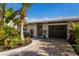 Modern home exterior with lush tropical landscaping at 213 83Rd St # East, Holmes Beach, FL 34217