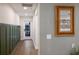 Bright hallway with wood floors, green board and batten, and a view to backyard at 213 83Rd St # East, Holmes Beach, FL 34217