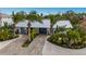 Luxury home with a metal roof and tropical landscaping at 213 83Rd St # East, Holmes Beach, FL 34217
