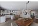 Open concept kitchen with island, white cabinets, and wood flooring at 213 83Rd St # East, Holmes Beach, FL 34217