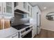 Modern kitchen range and white cabinets with quartz countertops at 213 83Rd St # East, Holmes Beach, FL 34217
