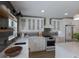 White kitchen with gray subway tile backsplash and gold accents at 213 83Rd St # East, Holmes Beach, FL 34217
