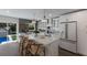 Modern kitchen island with white cabinets and a view of the backyard pool at 213 83Rd St # East, Holmes Beach, FL 34217