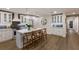 Modern kitchen with white cabinets, a large island, and sleek appliances at 213 83Rd St # East, Holmes Beach, FL 34217
