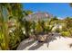 Relaxing patio area with a bistro set under a striped umbrella at 213 83Rd St # East, Holmes Beach, FL 34217