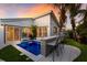 Private backyard with a plunge pool, bar seating, and fire pit at 213 83Rd St # East, Holmes Beach, FL 34217