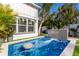 Relaxing pool with a waterfall feature and patio seating at 213 83Rd St # East, Holmes Beach, FL 34217