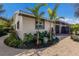 Landscaped side yard with tropical plants and a gravel pathway at 213 83Rd St # East, Holmes Beach, FL 34217
