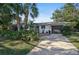 Attractive mid-century modern home with landscaped yard and driveway at 2814 Suncrest Dr, Sarasota, FL 34239