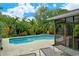 Inviting pool with surrounding patio and tropical landscaping at 2828 Grand Cayman St, Sarasota, FL 34231